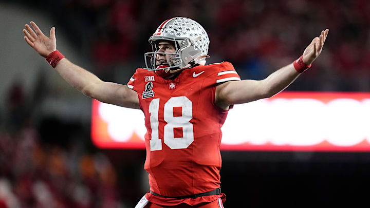 Ohio State Buckeyes quarterback Will Howard (18) celebrates a touchdown by running back TreVeyon Henderson during the second half of the College Football Playoff first round game against the Tennessee Volunteers at Ohio Stadium in Columbus on Dec. 22, 2024. Ohio State won 42-17.
