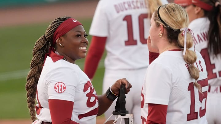 Feb 13, 2026; Tuscaloosa, AL, USA; Alabama pitcher Vic Moten smiles a she talks with first baseman Brooke Wells as they start an inning against Purdue at Rhoads Stadium in the East Bama Bash, the home opening weekend tournament. Feb 13, 2026; Tuscaloosa, AL, USA; Alabama pitcher Vic Moten smiles a she talks with first baseman Brooke Wells as they start an inning against Purdue at Rhoads Stadium in the East Bama Bash, the home opening weekend tournament.