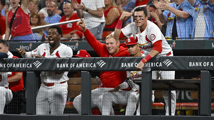 Sep 18, 2024; St. Louis, Missouri, USA;  St. Louis Cardinals right fielder Lars Nootbaar (21)  Luken Baker (26) and right fielder Jordan Walker (18) reacts after first baseman Paul Goldschmidt (not pictured) hit a one run triple against the Pittsburgh Pirates during the third inning at Busch Stadium. Mandatory Credit: Jeff Curry-Imagn Images