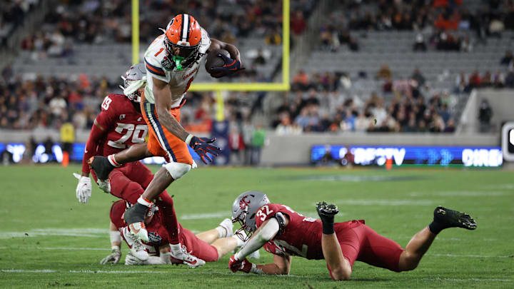 Dec 27, 2024; San Diego, CA, USA; Syracuse Orange running back LeQuint Allen (1) runs the ball against Washington State Cougars defensive back Tanner Moku (32) during the second quarter at Snapdragon Stadium. Mandatory Credit: Abe Arredondo-Imagn Images