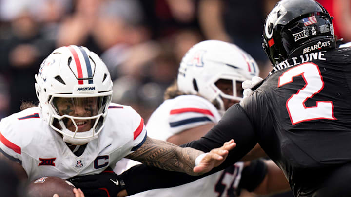 Cincinnati Bearcats defensive lineman Dontay Corleone (2) tackles Arizona Wildcats quarterback Noah Fifita (1) in the fourth quarter of the NCAA football game at Nippert Stadium in Cincinnati on Nov. 15, 2025. Cincinnati Bearcats defensive lineman Dontay Corleone (2) tackles Arizona Wildcats quarterback Noah Fifita (1) in the fourth quarter of the NCAA football game at Nippert Stadium in Cincinnati on Nov. 15, 2025.