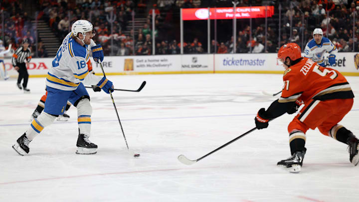 Mar 8, 2026; Anaheim, California, USA;  St. Louis Blues center Robert Thomas (18) passes the puck against Anaheim Ducks defenseman Olen Zellweger (51) during the third period at Honda Center. Mandatory Credit: Kiyoshi Mio-Imagn Images