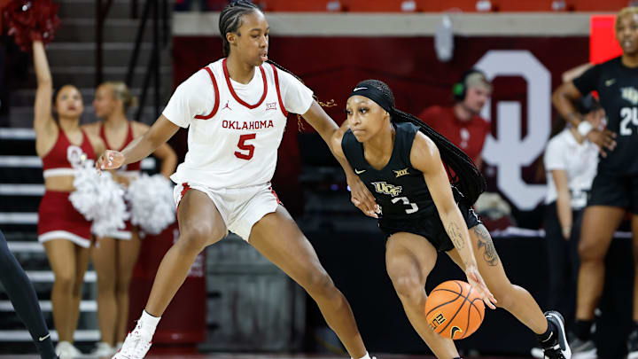 UCF Knights guard Kaitlin Peterson (3) moves around Oklahoma Sooners forward Kiersten Johnson (5) during the second half of an NCAA Women's Basketball game at Lloyd Noble Center in Norman, Okla., Saturday, Dec. 30, 2023. Oklahoma won 69-52.