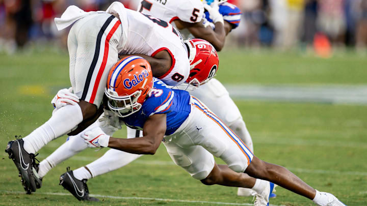 Florida Gators cornerback Jason Marshall Jr. (3) tackles Georgia Bulldogs wide receiver Dominic Lovett (6) during the second half at Everbank Stadium in Jacksonville, FL on Saturday, October 28, 2023. [Matt Pendleton/Gainesville Sun]