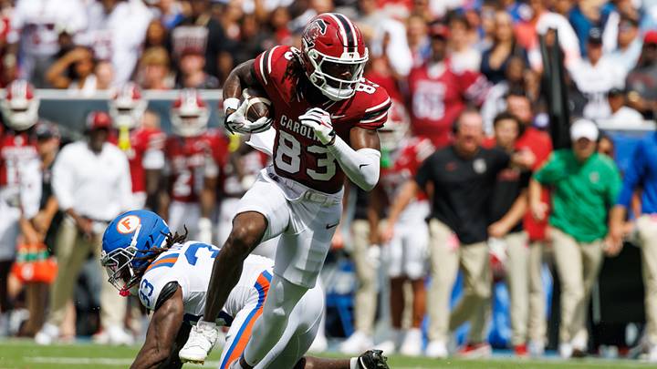 Oct 10, 2026; Gainesville, Florida, USA;  South Carolina Gamecocks wide receiver DJ Black (83) breaks a tackle from Florida Gators safety DJ Coleman (33) during the first half at Ben Hill Griffin Stadium.  Mandatory Credit: Matt Pendleton-Imagn Images