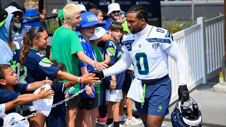 Jul 27, 2024; Renton, WA, USA; Seattle Seahawks linebacker Tyrel Dodson (0) interacts with fans before training camp at Virginia Mason Athletic Center. Mandatory Credit: Steven Bisig-Imagn Images Jul 27, 2024; Renton, WA, USA; Seattle Seahawks linebacker Tyrel Dodson (0) interacts with fans before training camp at Virginia Mason Athletic Center. Mandatory Credit: Steven Bisig-Imagn Images