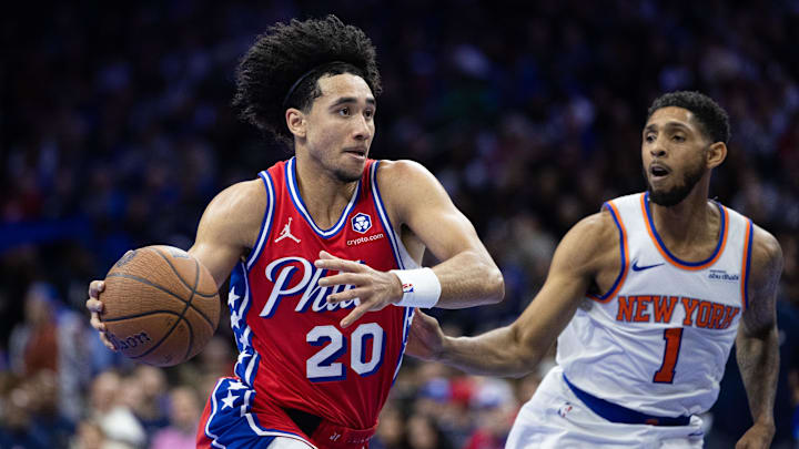 Nov 12, 2024; Philadelphia, Pennsylvania, USA; Philadelphia 76ers guard Jared McCain (20) drives past New York Knicks guard Cameron Payne (1) during the third quarter at Wells Fargo Center. Mandatory Credit: Bill Streicher-Imagn Images
