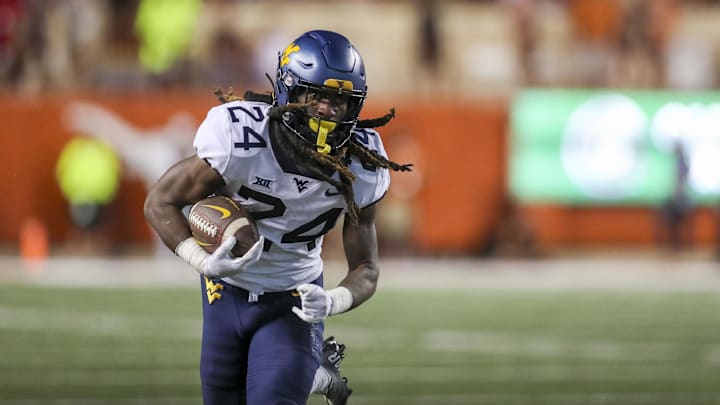 Oct 1, 2022; Austin, Texas, USA; West Virginia Mountaineers running back Tony Mathis Jr. (24) runs the ball against the Texas Longhorns during the fourth quarter at Darrell K Royal-Texas Memorial Stadium. Mandatory Credit: Ben Queen-Imagn Images