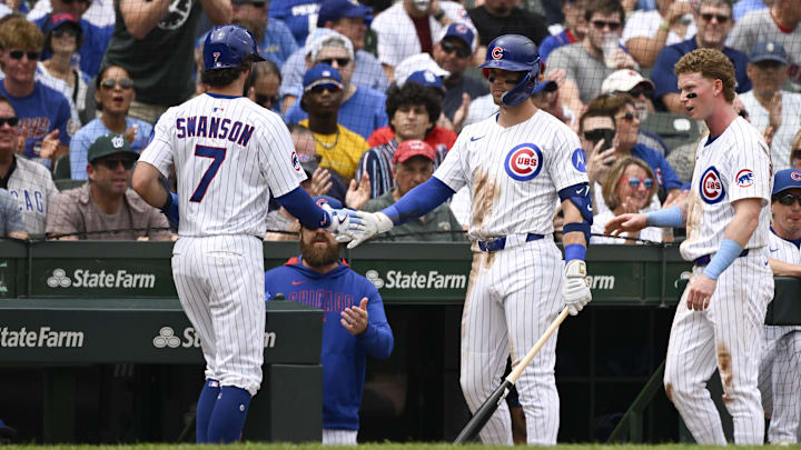 Jul 20, 2025; Chicago, Illinois, USA; Chicago Cubs shortstop Dansby Swanson (7) high fives second baseman Nico Hoerner (2) after he scores against the Boston Red Sox during the second inning at Wrigley Field. Jul 20, 2025; Chicago, Illinois, USA; Chicago Cubs shortstop Dansby Swanson (7) high fives second baseman Nico Hoerner (2) after he scores against the Boston Red Sox during the second inning at Wrigley Field.