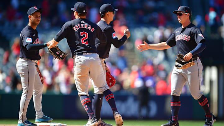 May 26, 2024; Anaheim, California, USA; Cleveland Guardians second base Andres Gimenez (0) outfielder Tyler Freeman (2) celebrate the victory against the Los Angeles Angels at Angel Stadium. Mandatory Credit: Gary A. Vasquez-Imagn Images