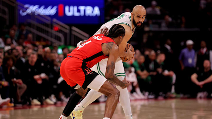 Jan 3, 2025; Houston, Texas, USA; Boston Celtics guard Derrick White (9) handles the ball against Houston Rockets guard Jalen Green (4) during the game at Toyota Center. Mandatory Credit: Erik Williams-Imagn Images
