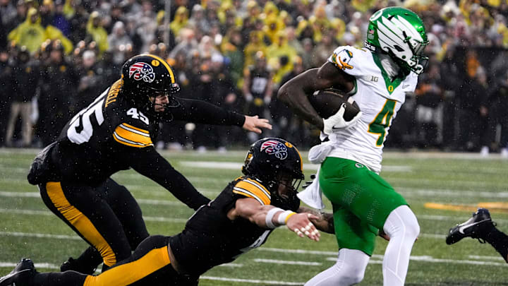Iowa Hawkeyes defensive back Koen Entringer (4) dives for Oregon Ducks wide receiver Malik Benson (4)