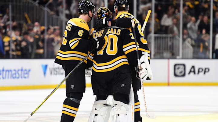 Nov 7, 2024; Boston, Massachusetts, USA;  Boston Bruins defenseman Mason Lohrei (6) and defenseman Nikita Zadorov (91) celebrate with goaltender Joonas Korpisalo (70) after defeating the Calgary Flames in overtime at TD Garden. Mandatory Credit: Bob DeChiara-Imagn Images
