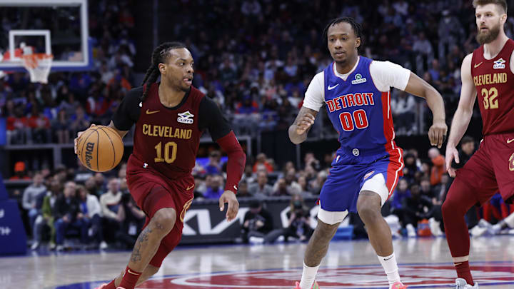 Mar 28, 2025; Detroit, Michigan, USA;  Cleveland Cavaliers guard Darius Garland (10) dribbles on Detroit Pistons forward Ronald Holland II (00) in the second half at Little Caesars Arena. Mandatory Credit: Rick Osentoski-Imagn Images