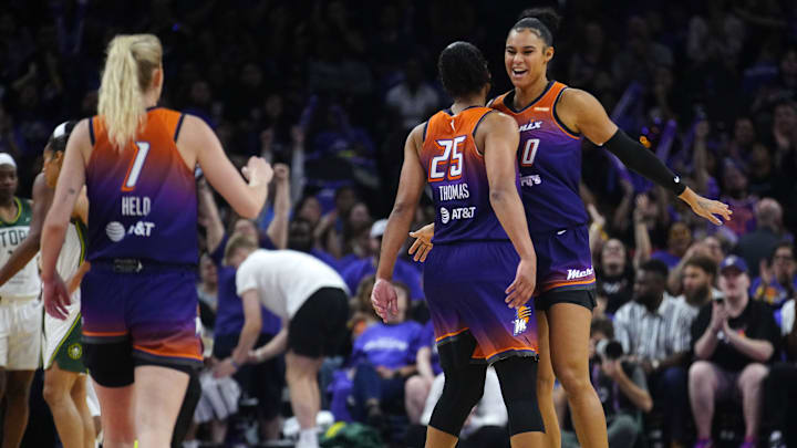 Phoenix Mercury forwards Satou Sabally (0) and Alyssa Thomas (25) and guard Lexi Held (1) celebrate after forcing a Seattle Storm timeout during the Mercury home opener in the PHX Arena in Phoenix on May 17, 2025.