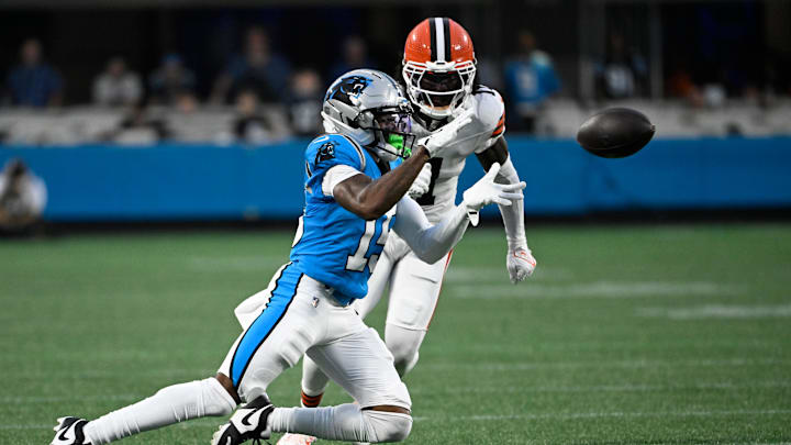 Aug 8, 2025; Charlotte, North Carolina, USA;  Carolina Panthers wide receiver Jimmy Horn Jr. (15) catches the ball as Cleveland Browns cornerback Tony Brown II (11) defends in the second quarter at Bank of America Stadium. Mandatory Credit: Bob Donnan-Imagn Images