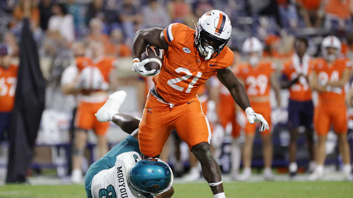 Aug 30, 2025; Charlottesville, Virginia, USA; Virginia Cavaliers running back Harrison Waylee (21) carries the ball as Coastal Carolina Chanticleers cornerback Myles Mooyoung (8) defends during the second half at Scott Stadium. Mandatory Credit: Amber Searls-Imagn Images Aug 30, 2025; Charlottesville, Virginia, USA; Virginia Cavaliers running back Harrison Waylee (21) carries the ball as Coastal Carolina Chanticleers cornerback Myles Mooyoung (8) defends during the second half at Scott Stadium. Mandatory Credit: Amber Searls-Imagn Images
