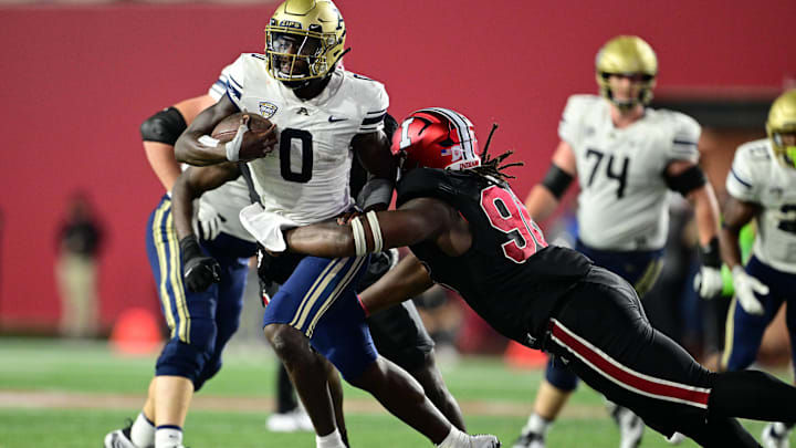 Sep 23, 2023; Bloomington, Indiana, USA; Akron Zips quarterback DJ Irons (0) is tackled by Indiana