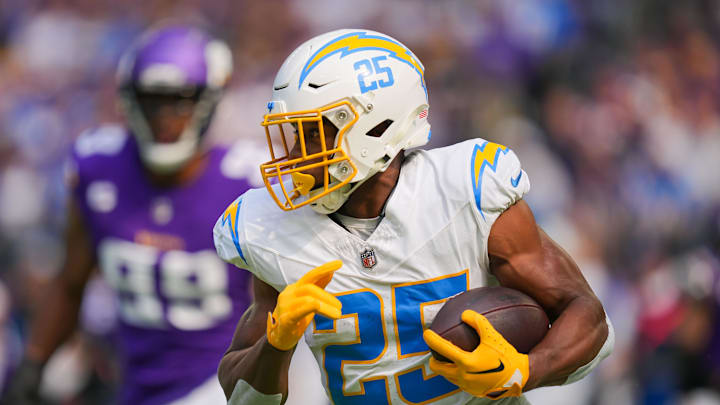 Sep 24, 2023; Minneapolis, Minnesota, USA; Los Angeles Chargers running back Joshua Kelley (25) runs with the ball against the Minnesota Vikings in the first quarter at U.S. Bank Stadium. Mandatory Credit: Brad Rempel-Imagn Images