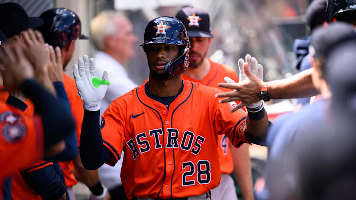 Houston Astros Brice Matthews walking past his teammates and high-fiving them