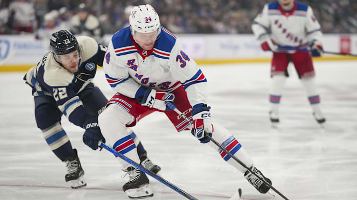 Feb 8, 2025; Columbus, Ohio, USA; New York Rangers right wing Arthur Kaliyev (34) skates with the puck against Columbus Blue Jackets defenseman Jordan Harris (22) in the first period at Nationwide Arena. Mandatory Credit: Aaron Doster-Imagn Images