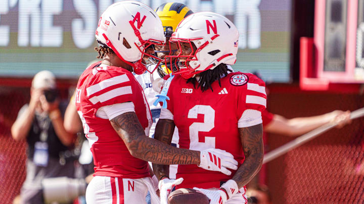 Jacory Barney Jr. and Nyziah Hunter celebrate after the hail-mary touchdown grab to end the first half. 