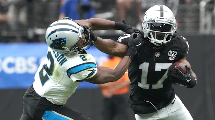 Sep 22, 2024; Paradise, Nevada, USA; Las Vegas Raiders wide receiver Davante Adams (17) carries the ball against Carolina Panthers cornerback Michael Jackson (2) in the first half at Allegiant Stadium. Mandatory Credit: Kirby Lee-Imagn Images