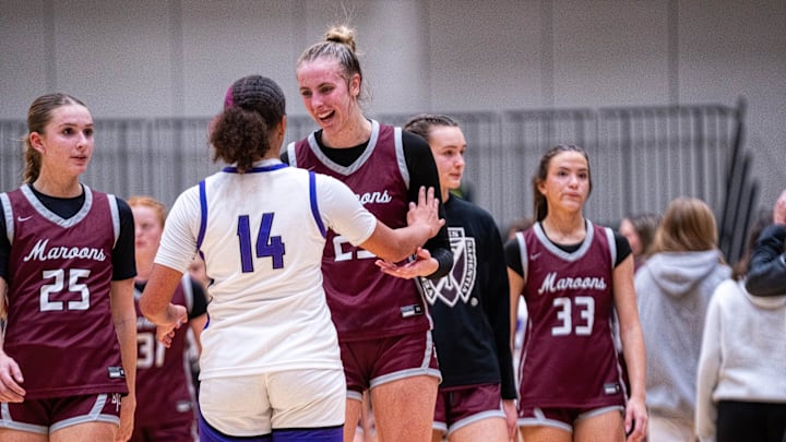 Johnston's Arianna Phillips (14) talks with Dowling’s Ellie Muller (23) after their game on Dec. 16, 2025, at Johnston High School. Johnston's Arianna Phillips (14) talks with Dowling’s Ellie Muller (23) after their game on Dec. 16, 2025, at Johnston High School.