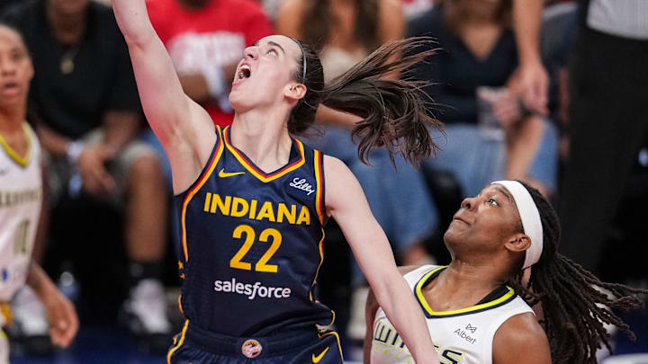 Indiana Fever guard Caitlin Clark (22) goes in for a lay-up against Dallas Wings forward Myisha Hines-Allen (2) on Sunday, July 13, 2025, during the game at Gainbridge Fieldhouse in Indianapolis.