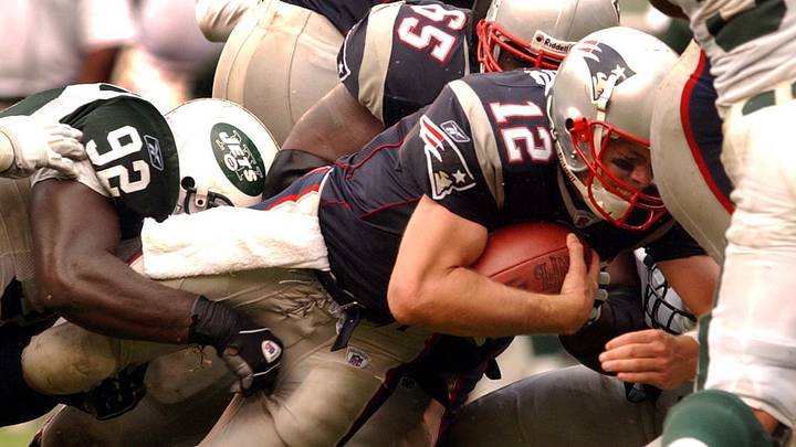 Sep 15, 2002; East Rutherford, New Jersey, USA; New England Patriots quarterback Tom Brady (12) is tackled by New York Jets defensive end Shaun Ellis in the second quarter of the Patriots victory at Giants Stadium. Mandatory Credit: Mary Murphy/Providence Journal-USA TODAY NETWORK Sep 15, 2002; East Rutherford, New Jersey, USA; New England Patriots quarterback Tom Brady (12) is tackled by New York Jets defensive end Shaun Ellis in the second quarter of the Patriots victory at Giants Stadium. Mandatory Credit: Mary Murphy/Providence Journal-USA TODAY NETWORK