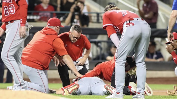 Angels starting pitcher Chase Silseth (63) lays on the ground after getting hit in the head by a throw in the fourth inning against the New York Mets at Citi Field on Aug. 26, 2023.