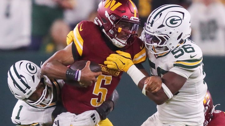 Green Bay Packers defensive end Micah Parsons (1) and linebacker Edgerrin Cooper sack Commanders quarterback Jayden Daniels.