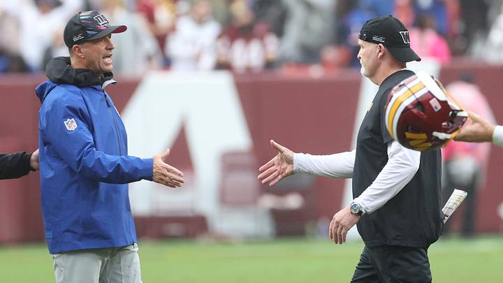 Oct 11, 2026; Landover, Maryland, USA;  New York Giants head coach John Harbaugh shakes hands with Washington Commanders head coach Dan Quinn after the game at Northwest Stadium.   