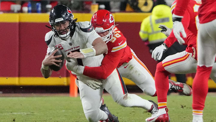 Jan 18, 2025; Kansas City, Missouri, USA; Houston Texans quarterback C.J. Stroud (7) is sacked by Kansas City Chiefs defensive end George Karlaftis (56) during the fourth quarter of a 2025 AFC divisional round game at GEHA Field at Arrowhead Stadium. Mandatory Credit: Denny Medley-Imagn Images