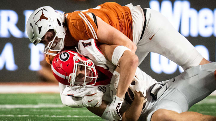 Oct 19, 2024; Austin, Texas, USA; Texas Longhorns linebacker Ethan Burke (91) tackles Georgia Bulldogs tight end Lawson Luckie (7) in the first half at Darrell K. Royal Texas Memorial Stadium. Mandatory Credit: Sara Diggins/USA TODAY Network via Imagn Images