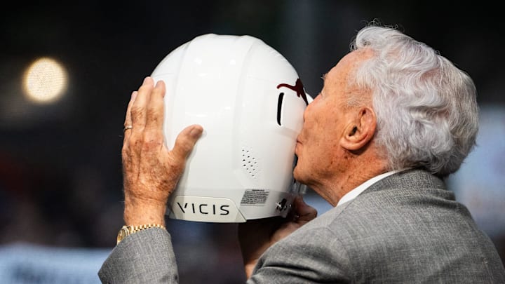 Analyst Lee Corso kisses a Texas football helmet before ESPN's College Game Day, at the University of Texas on the South Mall, ahead of the Longhorns' game against the Georgia Bulldogs in Austin, Oct. 19, 2024.
