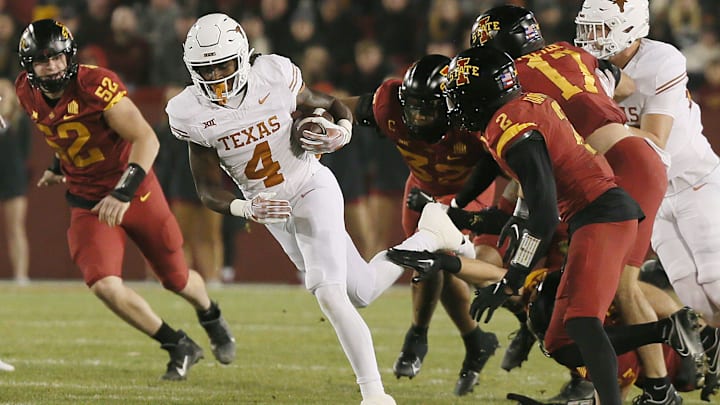 Texas Longhorns running back CJ Baxter (4) runs with the ball for a first down against Iowa State during the first quarter in the Big-12 football showdown at Jack Trice Stadium on Saturday, Nov. 18, 2023, in Ames, Iowa
