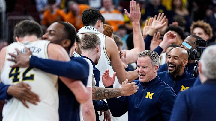 Michigan head coach Dusty May high-fives players to celebrate 95-62 win over Tennessee at the NCAA Tournament Elite 8 round at United Center in Chicago on Sunday, March 29, 2026. Michigan head coach Dusty May high-fives players to celebrate 95-62 win over Tennessee at the NCAA Tournament Elite 8 round at United Center in Chicago on Sunday, March 29, 2026.