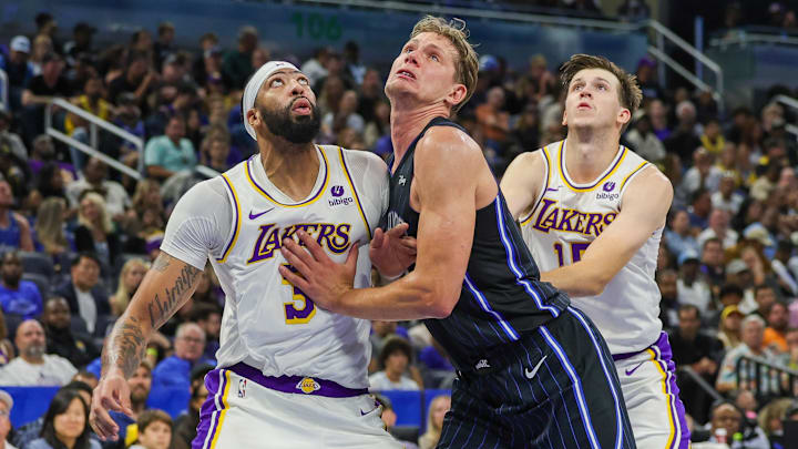 Orlando Magic center Moritz Wagner (21) Los Angeles Lakers forward Anthony Davis (3) and guard Austin Reaves (15) battle for the rebound during the second half at Amway Center.