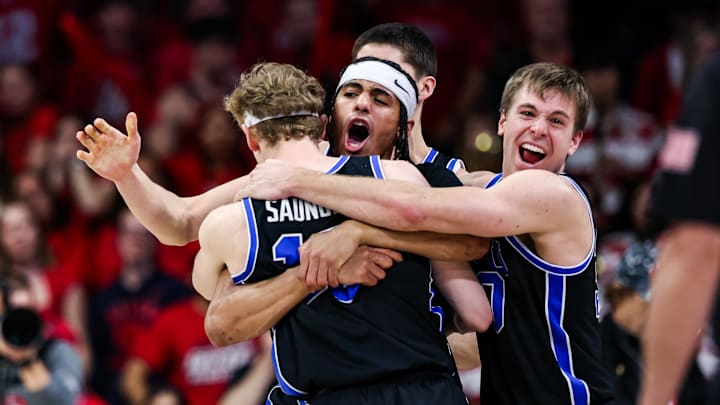 Feb 22, 2025; Tucson, Arizona, USA; BYU Cougars center Keba Keita (13), guard Trey Stewart (1) and guard Dallin Hall (30) celebrate a win against the Arizona Wildcats at the end of the game at McKale Center. Mandatory Credit: Aryanna Frank-Imagn Images