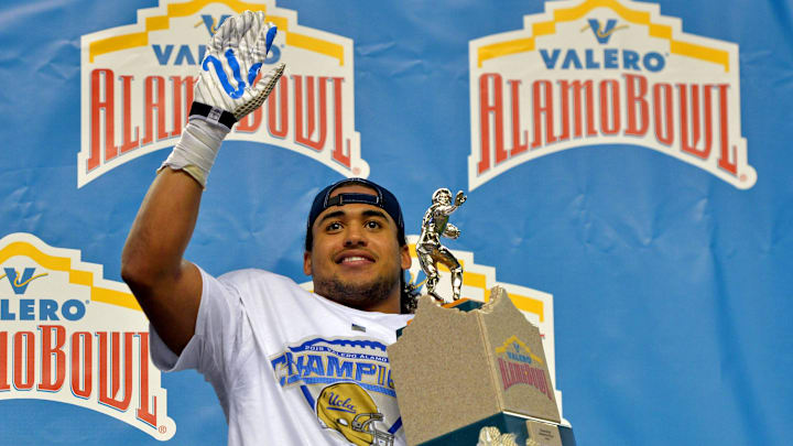 Jan 2, 2015; San Antonio, TX, USA; UCLA Bruins linebacker Eric Kendricks holds the outstanding defensive player trophy after the game against the Kansas State Wildcats in the 2015 Alamo Bowl at Alamodome. UCLA defeated Kansas State 40-35. Mandatory Credit: Kirby Lee-Imagn Images