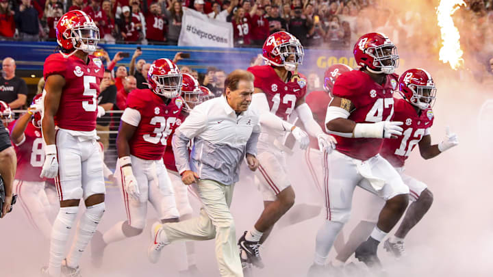 Dec 31, 2021; Arlington, Texas, USA; Alabama Crimson Tide head coach Nick Saban leads his team onto