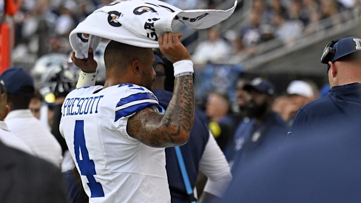 Dallas Cowboys quarterback Dak Prescott reacts on the bench against the Chicago Bears during the second half at Soldier Field. Dallas Cowboys quarterback Dak Prescott reacts on the bench against the Chicago Bears during the second half at Soldier Field.