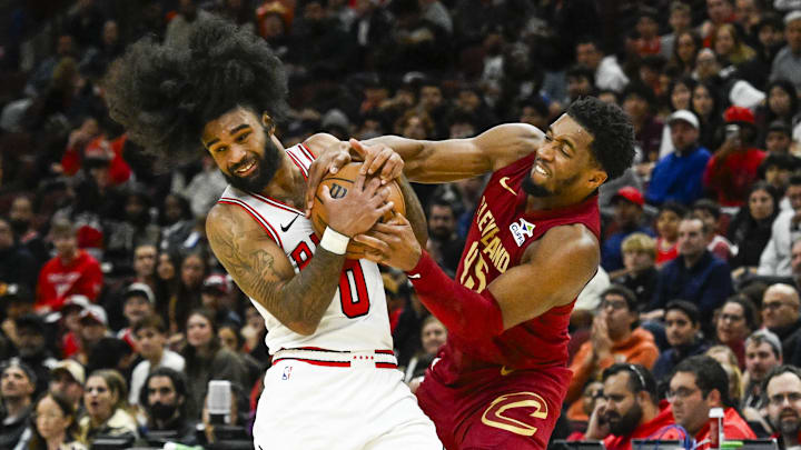 Chicago Bulls guard Coby White (0) and Cleveland Cavaliers guard Donovan Mitchell (45) fight for the ball during the second half at the United Center. Mandatory Credit: Matt Marton-Imagn Images