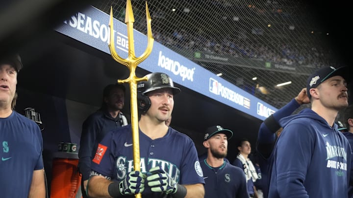 Oct 20, 2025; Toronto, Ontario, CAN; Seattle Mariners catcher Cal Raleigh (29) celebrates in the dugout after scoring against the Toronto Blue Jays in the fifth inning during game seven of the ALCS round for the 2025 MLB playoffs at Rogers Centre. Mandatory Credit: John E. Sokolowski-Imagn Images