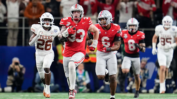 Ohio State Buckeyes defensive end Jack Sawyer (33) returns a fumble recovery for a touchdown after sacking Texas Longhorns quarterback Quinn Ewers (3) during the second half of the Cotton Bowl Classic College Football Playoff semifinal game at AT&T Stadium in Arlington, Texas on Jan. 10, 2025. Sawyer returned the fumble for a touchdown, and Ohio State won 28-14.