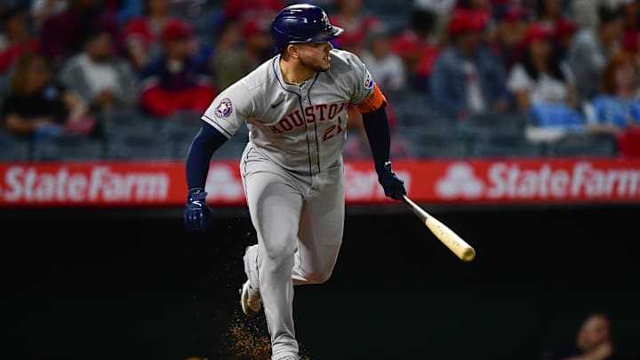 Yainer Diaz running out of the batters box wearing all grey uniform. 