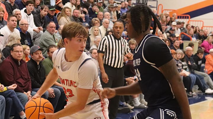 Cayden Masching of Pontiac looks for help as DePaul Prep's Rashaun Porter defends in the opening round of the 93rd Pontiac Holiday Tournament.