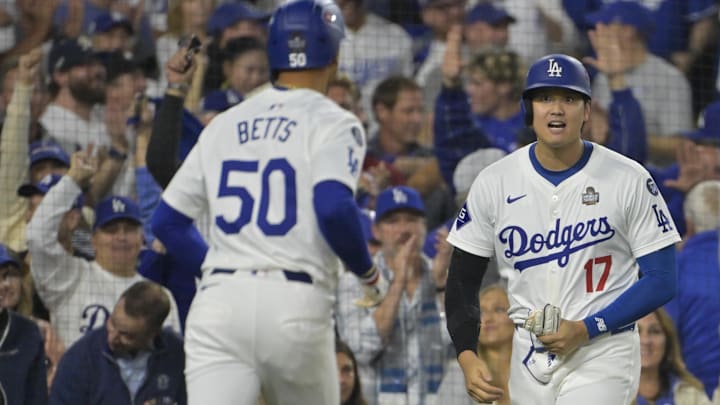 Oct 25, 2024; Los Angeles, California, USA; Los Angeles Dodgers designated hitter player Shohei Ohtani (17) celebrates with shortstop Mookie Betts (50) after scoring a run in the eighth inning against the New York Yankees during game one of the 2024 MLB World Series at Dodger Stadium. Mandatory Credit: Jayne Kamin-Oncea-Imagn Images Oct 25, 2024; Los Angeles, California, USA; Los Angeles Dodgers designated hitter player Shohei Ohtani (17) celebrates with shortstop Mookie Betts (50) after scoring a run in the eighth inning against the New York Yankees during game one of the 2024 MLB World Series at Dodger Stadium. Mandatory Credit: Jayne Kamin-Oncea-Imagn Images