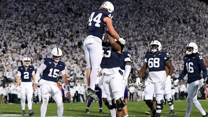 Penn State Nittany Lions tight end Tyler Warren (44) is lifted into the air by offensive lineman Nick Dawkins (53) after scoring a touchdown against the Washington Huskies during the second quarter at Beaver Stadium.